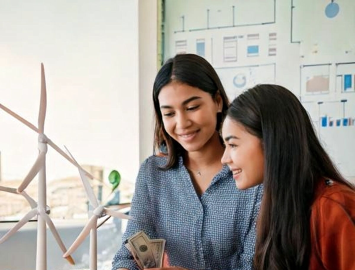 Two students reviewing their business results